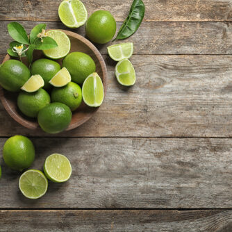 Bowl,With,Fresh,Ripe,Limes,On,Wooden,Background,,Top,View